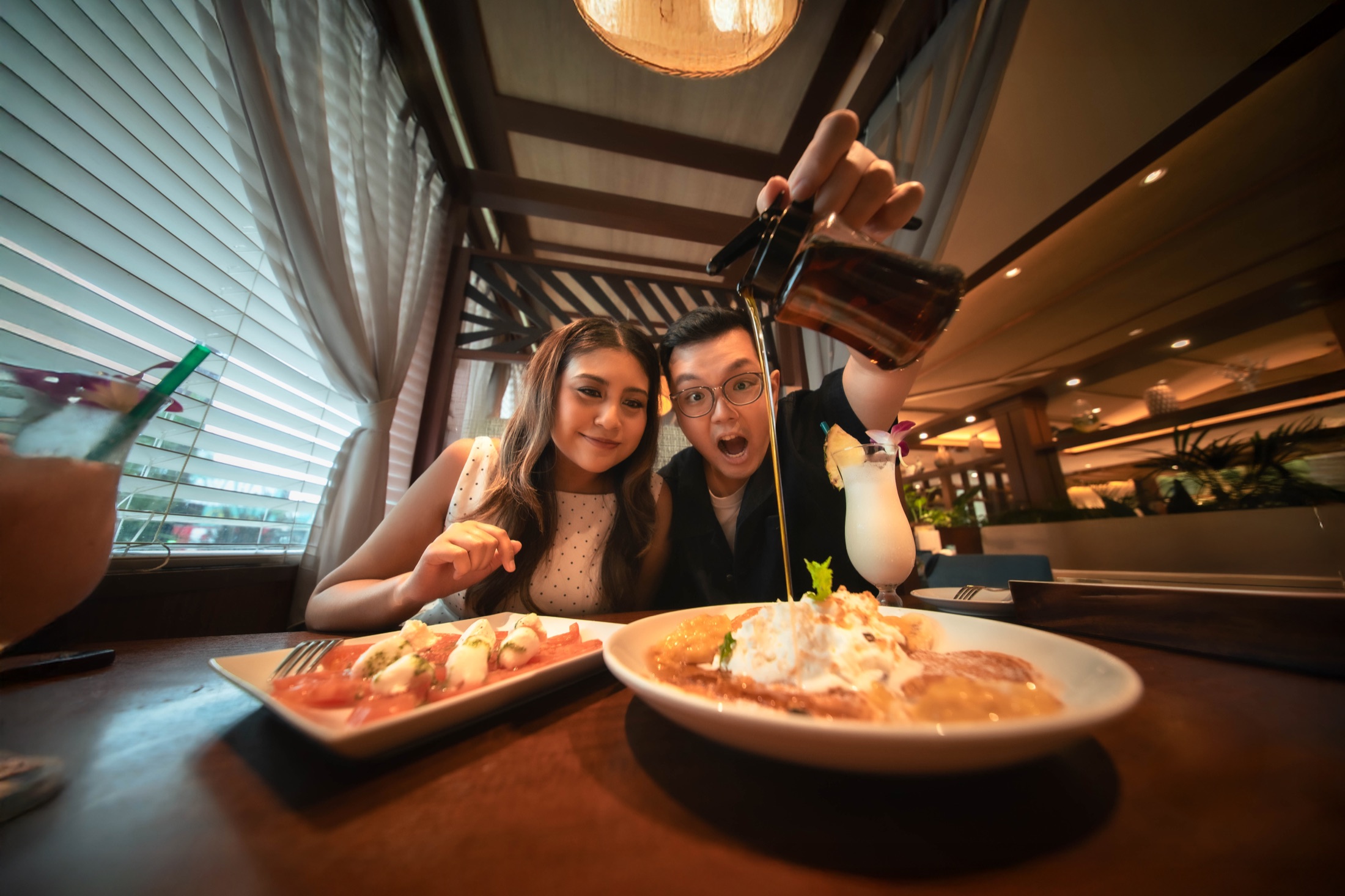 A playful moment over dessert