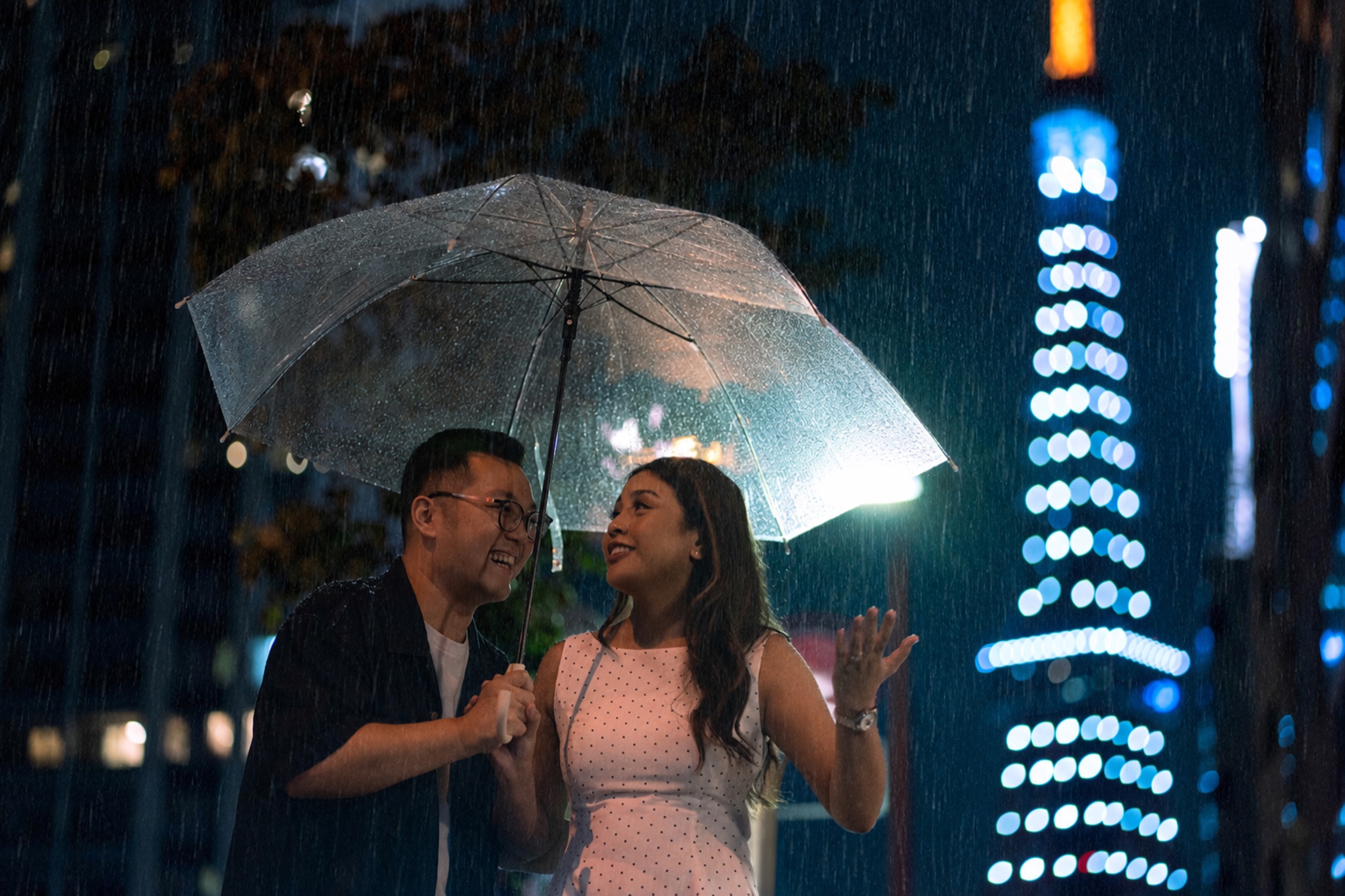 Declann and Afrina beneath an umbrella
